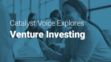 Team of professionals in a meeting, sharing a presentation on a laptop while discussing strategies and text: Catalyst Voice explores venture investing.