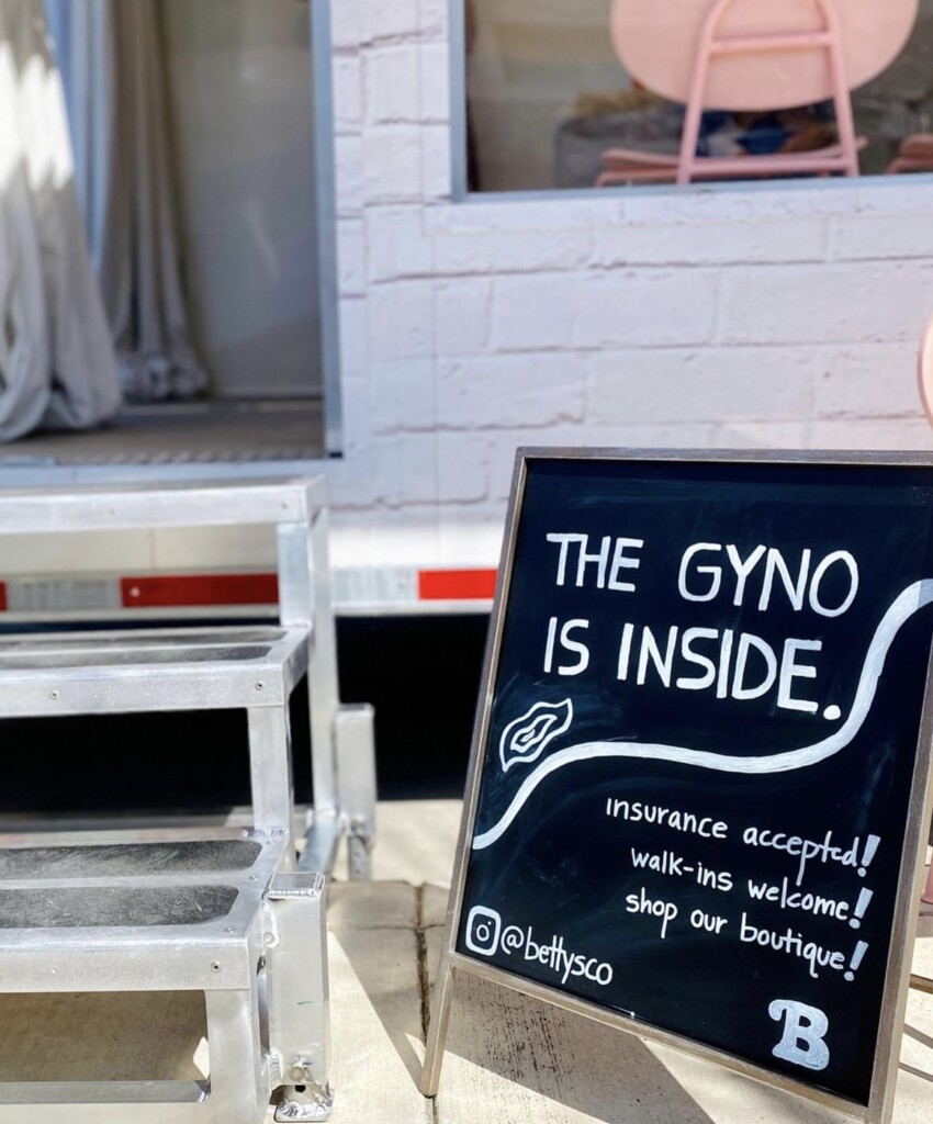 Sign outside a Betty's Co. trailer. It reads, "The Gyno is Inside."