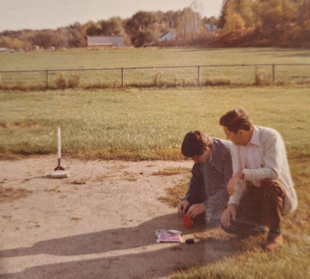 Teen and dad playing with RC airplane.