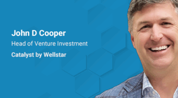 Smiling man on blue background with text: “John D Cooper — Head of Venture Investment, Catalyst by Wellstar.”