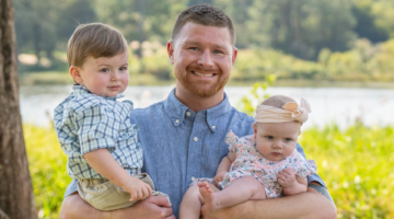 Hudson holds his two kids.