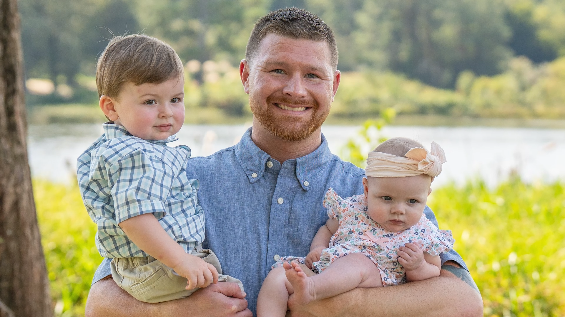 Hudson holds his two kids.