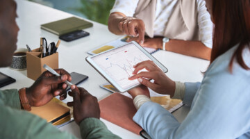 Business meeting, graph and digital tablet for people in office with budget, statistics and review. Financial, analysis and finance team online with chart, collaboration and budget planning or target.