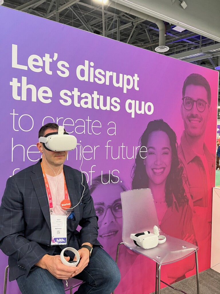 Man using VR glasses on a Catalyst by Wellstar booth.