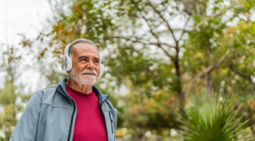 Senior man walking on public park.