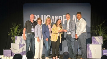 Catalyst team receives award on stage.