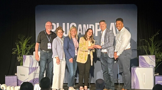 Catalyst team receives award on stage.