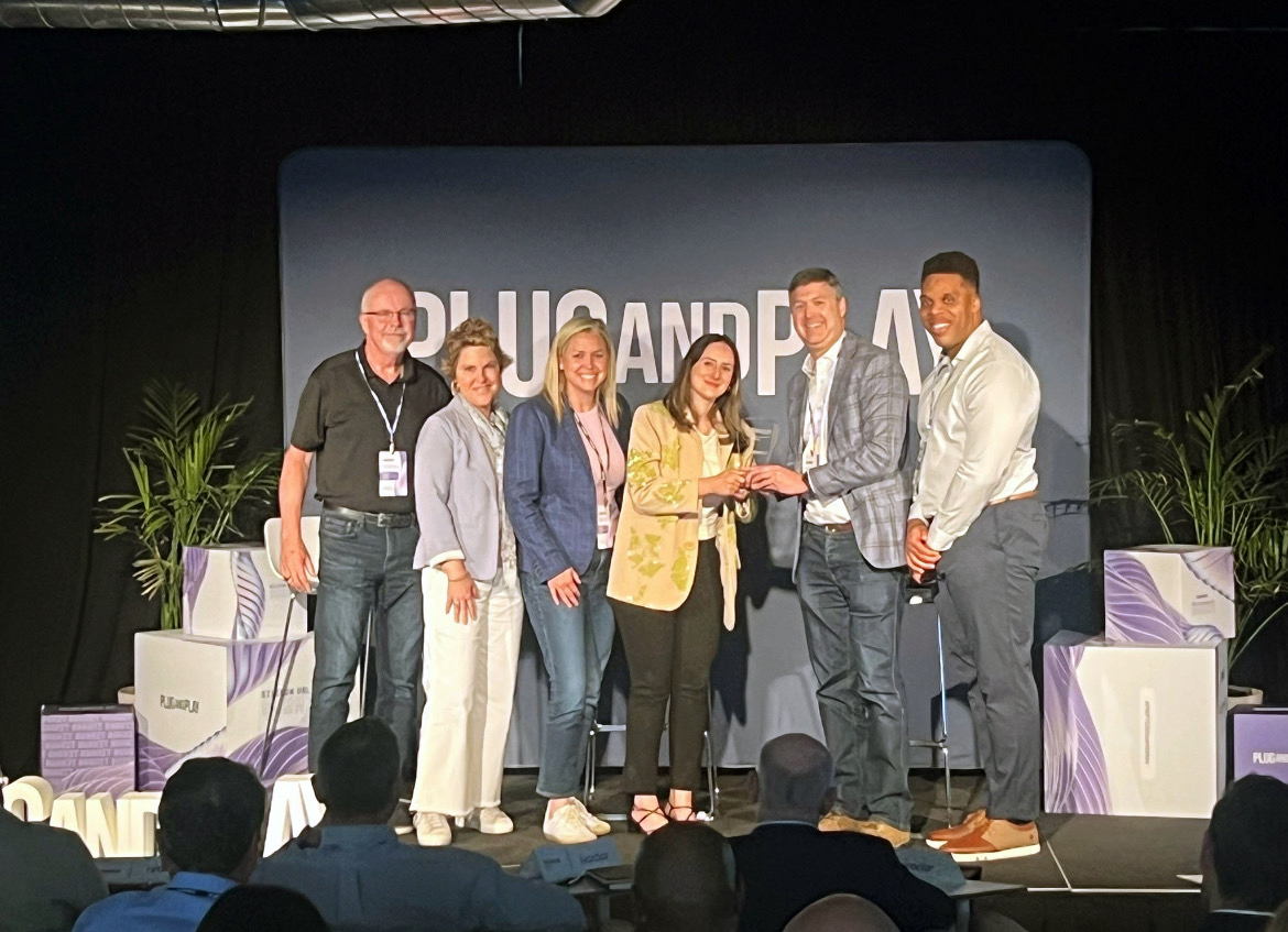 Catalyst team receives award on stage.