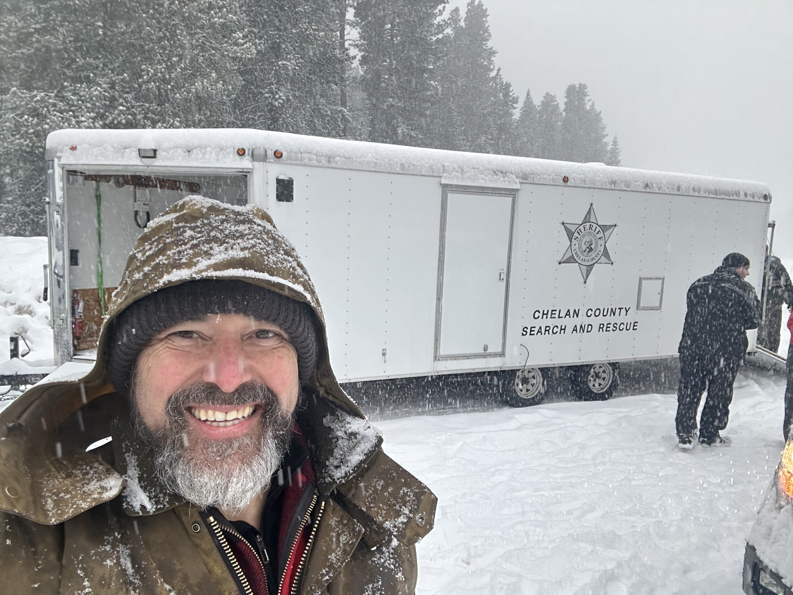 Ophir Ronen in a snowstorm in front of a trailer.