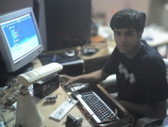 Ritukar programing a robot in a computer in 2005.